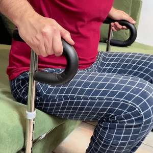SteadyRail mounted under sofa, angled view showing adjustable legs